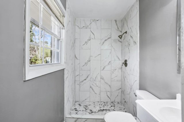 bathroom featuring a marble finish shower, marble finish floor, toilet, and vanity