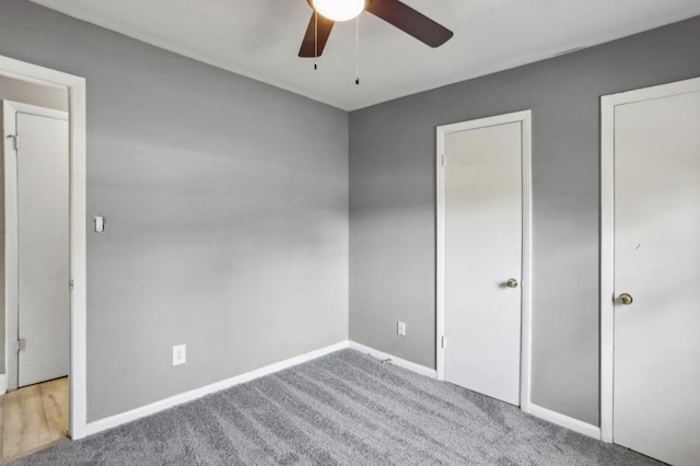 unfurnished bedroom featuring a ceiling fan, baseboards, and carpet floors