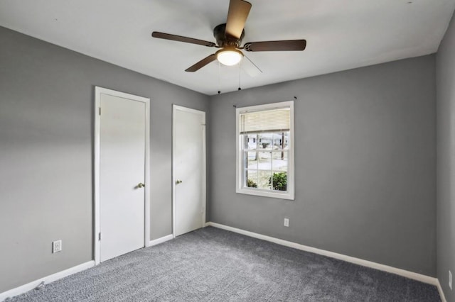 unfurnished bedroom featuring carpet, baseboards, and ceiling fan