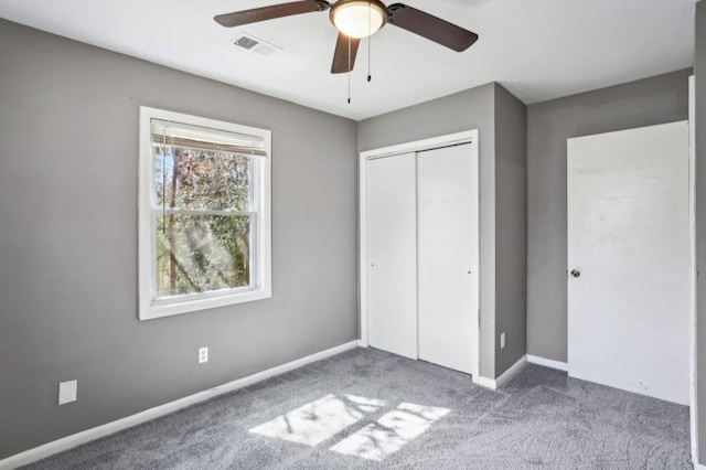 unfurnished bedroom featuring visible vents, a ceiling fan, a closet, carpet floors, and baseboards