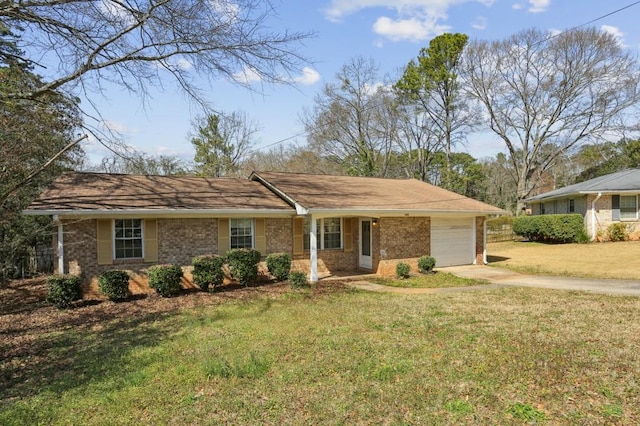 single story home with driveway, brick siding, an attached garage, and a front yard