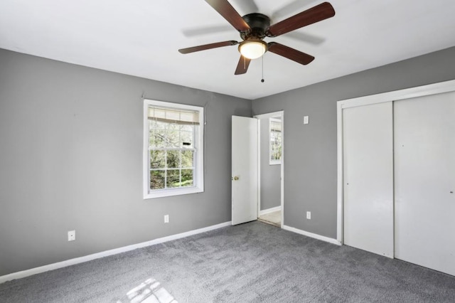 unfurnished bedroom featuring a closet, baseboards, a ceiling fan, and carpet floors