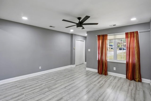 empty room with visible vents, a ceiling fan, recessed lighting, light wood finished floors, and baseboards