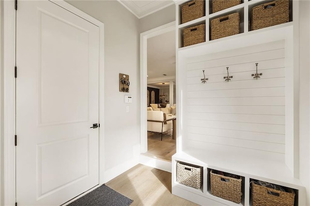 mudroom with crown molding and light wood-type flooring