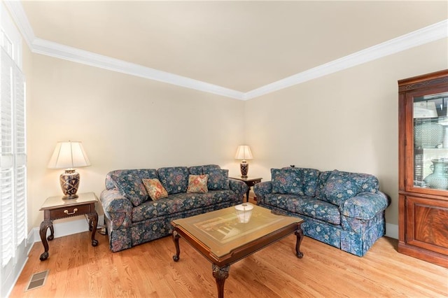 living room featuring light wood-type flooring and crown molding