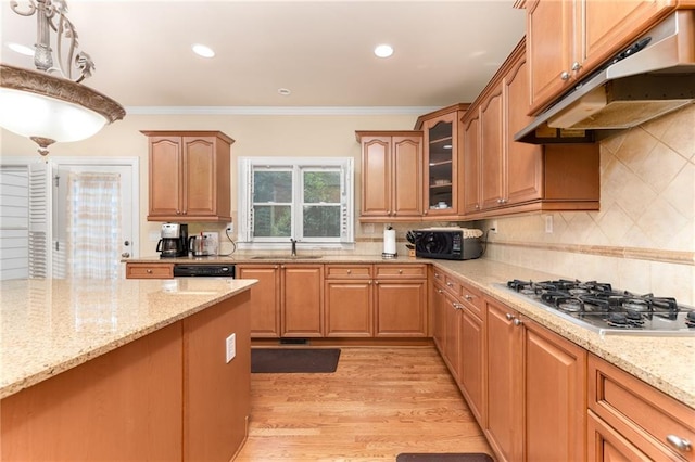 kitchen featuring light wood-type flooring, crown molding, stainless steel gas cooktop, and sink