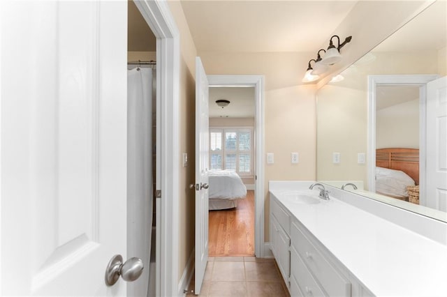 bathroom featuring tile patterned flooring, walk in shower, and vanity