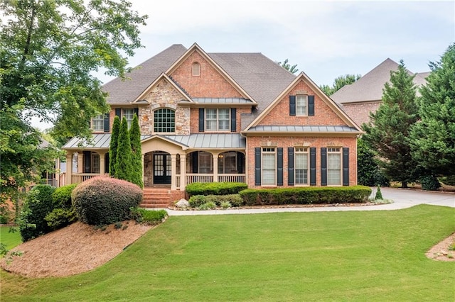 craftsman-style house featuring a porch and a front lawn