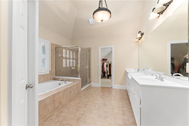 bathroom with vaulted ceiling, vanity, separate shower and tub, and tile patterned floors