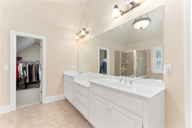 bathroom with vanity, vaulted ceiling, a shower with door, and tile patterned floors