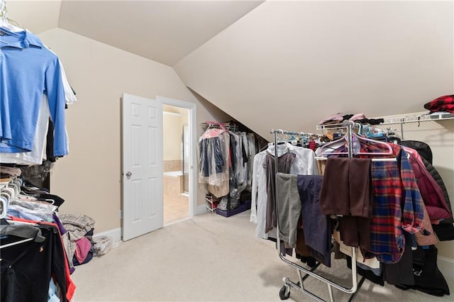 spacious closet with light carpet and lofted ceiling