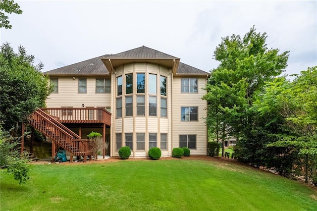 rear view of house featuring a yard and a deck