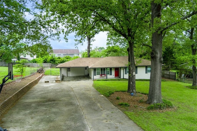 ranch-style home with covered porch, fence, driveway, and a front yard