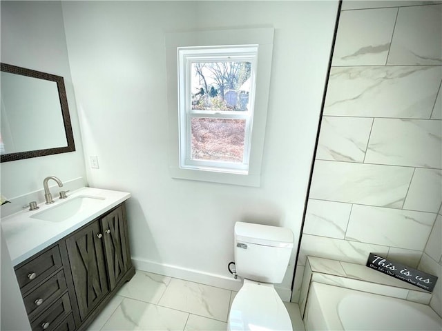 full bathroom featuring a tub to relax in, marble finish floor, toilet, vanity, and baseboards