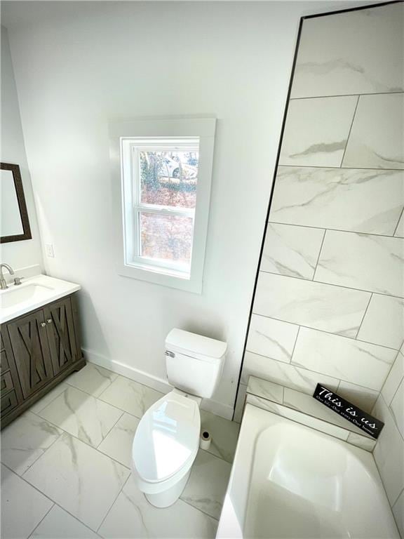 full bath featuring marble finish floor, toilet, vanity, baseboards, and a bath