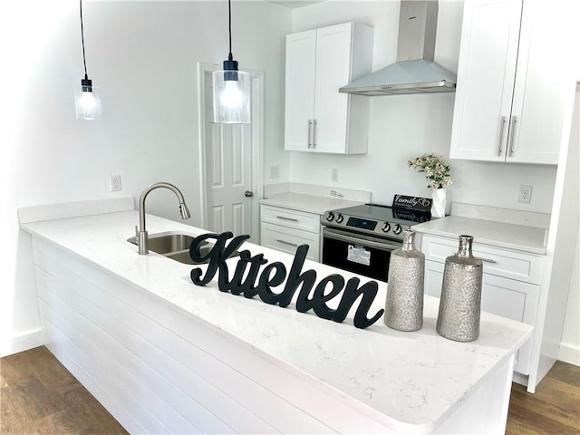 kitchen featuring pendant lighting, white cabinetry, a sink, stainless steel range with electric stovetop, and wall chimney exhaust hood