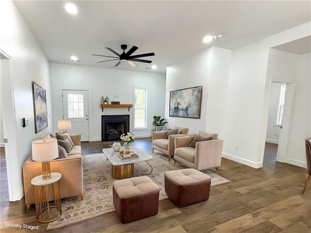 living room with recessed lighting, dark wood-style flooring, a fireplace, a ceiling fan, and baseboards