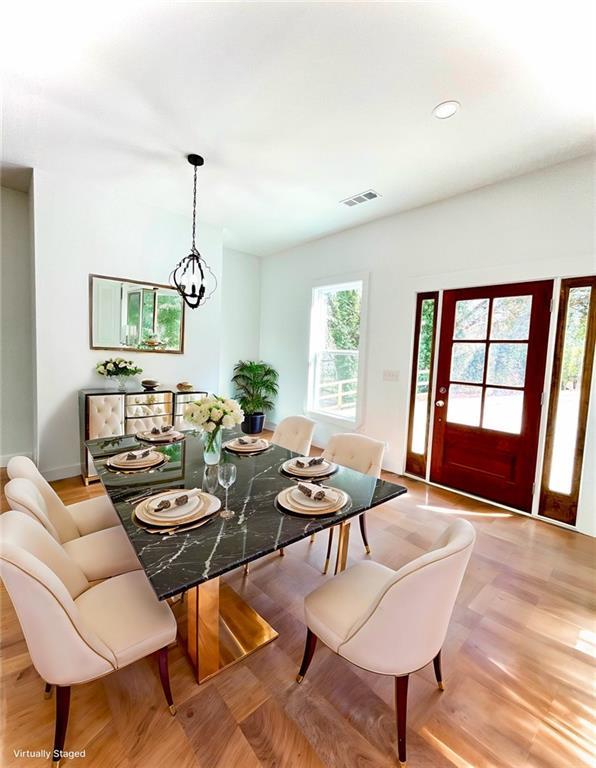 dining area with recessed lighting, light wood-type flooring, visible vents, and an inviting chandelier