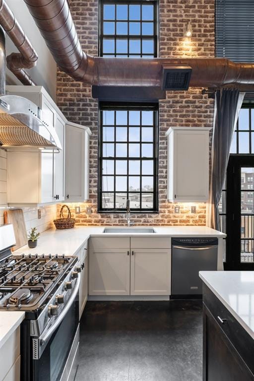 kitchen featuring dishwasher, sink, white cabinets, and gas range