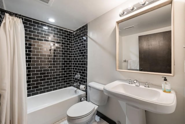 full bathroom with toilet, sink, and shower / bath combo with shower curtain