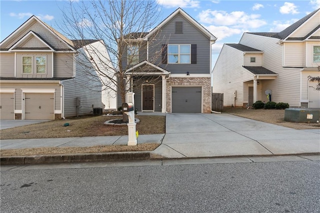 view of front of property featuring a garage and central AC unit