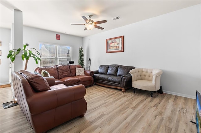 living room with light wood-type flooring and ceiling fan