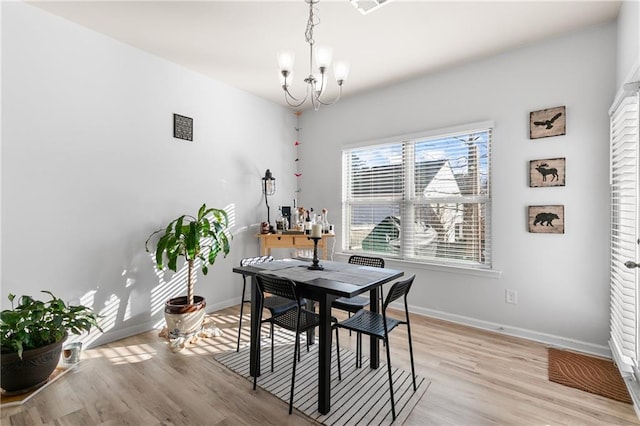 kitchen featuring ceiling fan with notable chandelier, sink, pendant lighting, dishwasher, and an island with sink