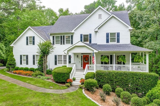 view of front of house featuring a front lawn and covered porch