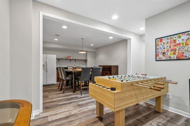 recreation room featuring recessed lighting, wood finished floors, and baseboards