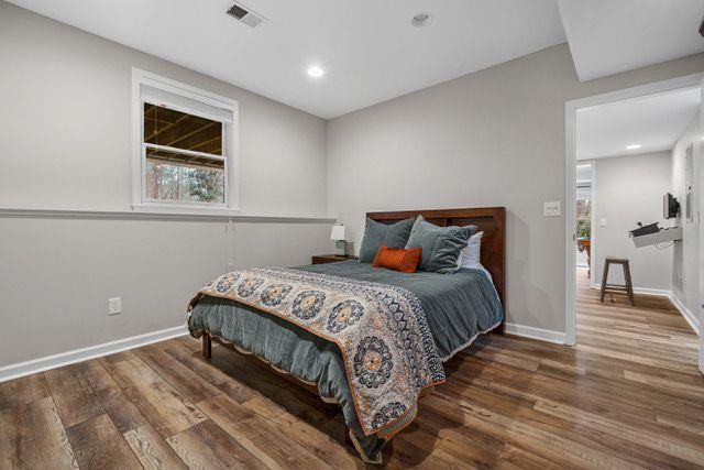 bedroom with dark wood-type flooring