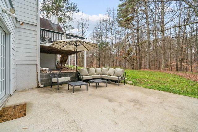 view of patio featuring an outdoor living space and stairs