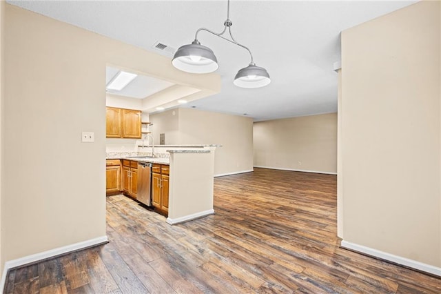 98 Hampshire Ct, Avondale Estates, GA 30002 - kitchen featuring stainless steel dishwasher, a peninsula, dark wood-style flooring, baseboards, and light countertops