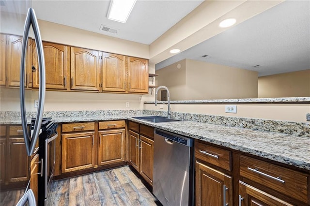 98 Hampshire Ct, Avondale Estates, GA 30002 - kitchen with stainless steel appliances, a sink, light wood-style flooring, light stone counters, and open shelves