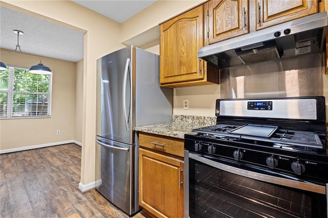 98 Hampshire Ct, Avondale Estates, GA 30002 - kitchen featuring stainless steel appliances, under cabinet range hood, baseboards, brown cabinets, and wood finished floors