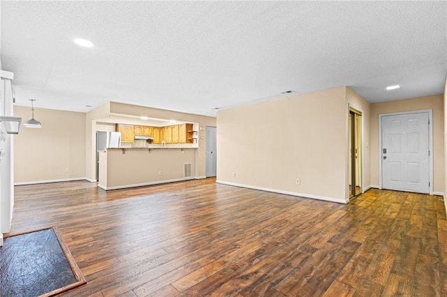 98 Hampshire Ct, Avondale Estates, GA 30002 - unfurnished living room featuring dark wood-style floors, baseboards, a textured ceiling, and recessed lighting