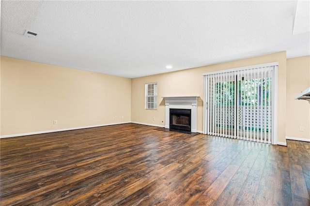 98 Hampshire Ct, Avondale Estates, GA 30002 - unfurnished living room with a fireplace with raised hearth, wood finished floors, baseboards, and recessed lighting