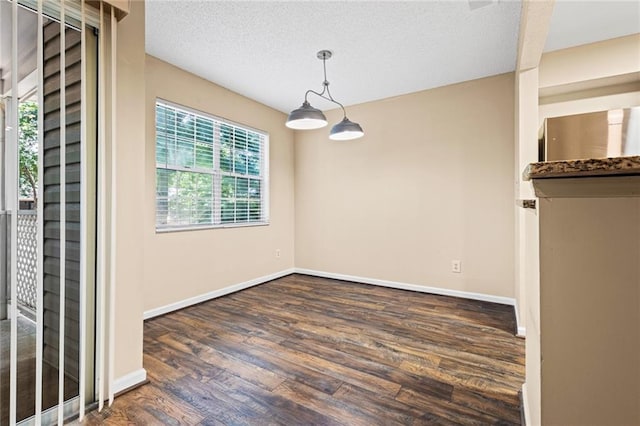 98 Hampshire Ct, Avondale Estates, GA 30002 - unfurnished dining area with wood finished floors, baseboards, and a textured ceiling