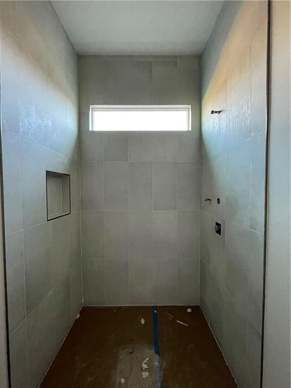 bathroom with a tile shower