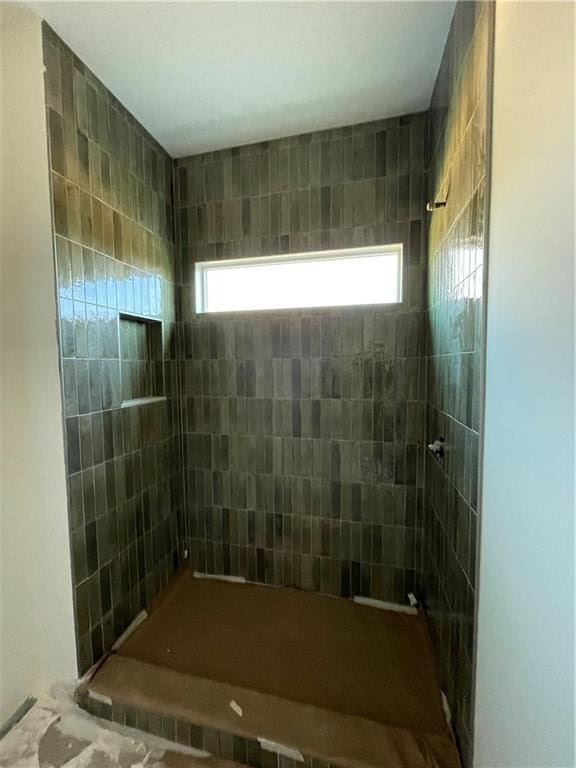 bathroom with a tile shower