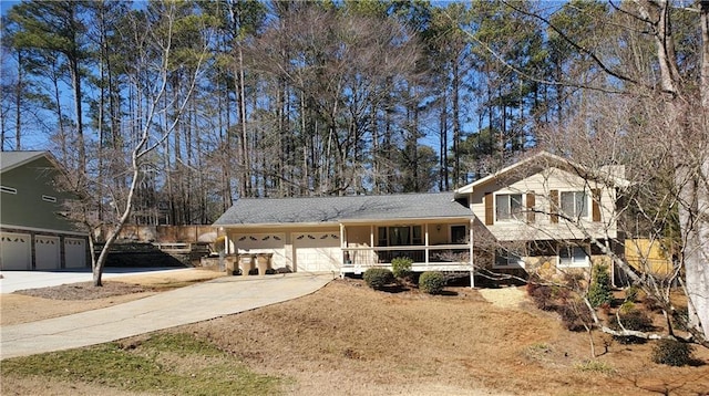 tri-level home featuring a garage and covered porch