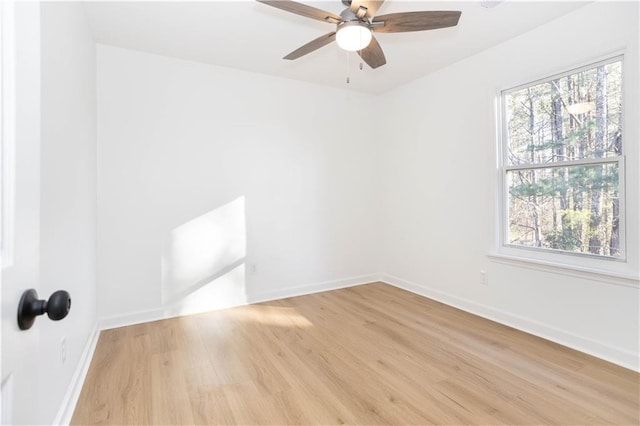 unfurnished room featuring light wood-type flooring, ceiling fan, and plenty of natural light