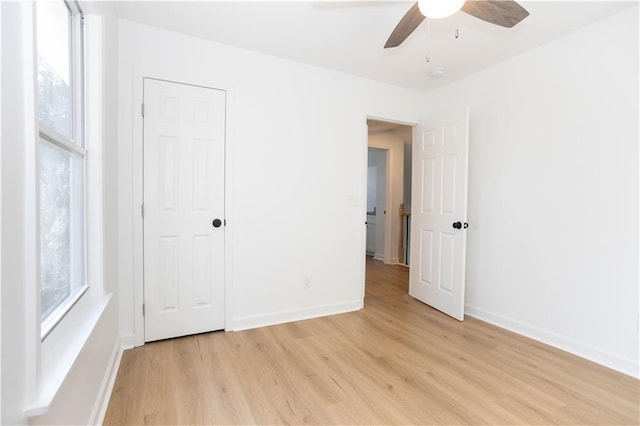 unfurnished bedroom featuring ceiling fan and light wood-type flooring