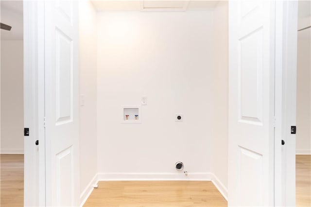 laundry area featuring washer hookup, light wood-type flooring, hookup for an electric dryer, and hookup for a gas dryer