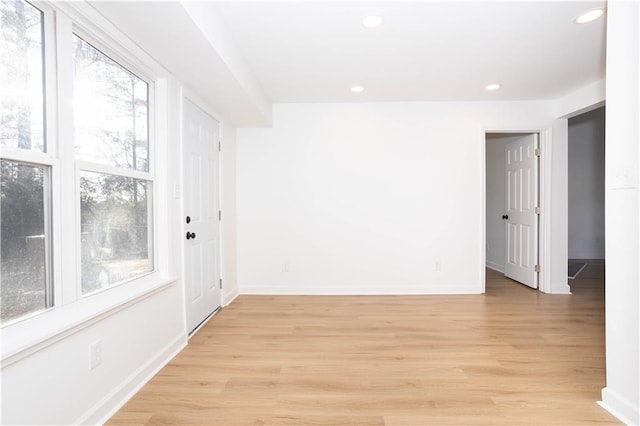 spare room with light hardwood / wood-style flooring