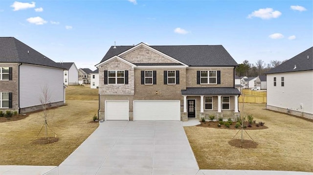 view of front of home with a garage, a front lawn, and covered porch