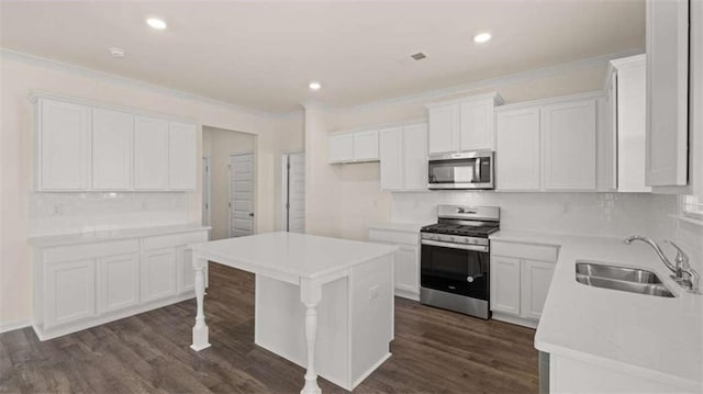 kitchen featuring white cabinetry, stainless steel appliances, dark hardwood / wood-style floors, and sink