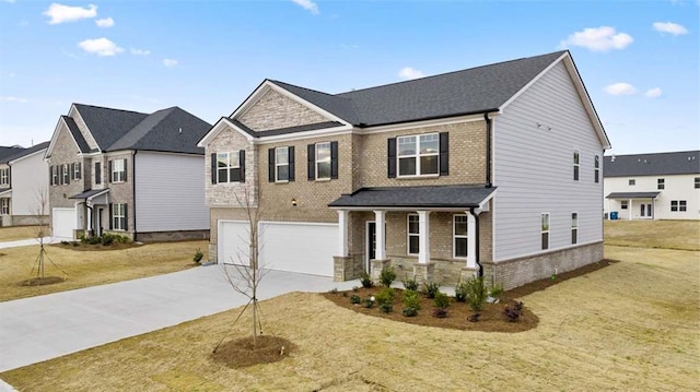 craftsman-style home with a garage, covered porch, and a front lawn