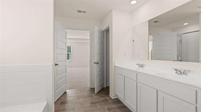 bathroom with vanity and a shower with shower door