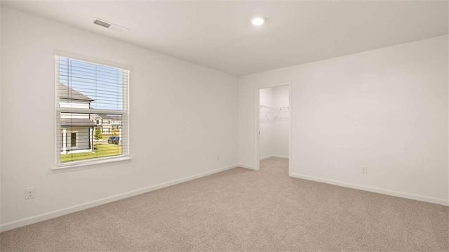 spare room featuring light colored carpet