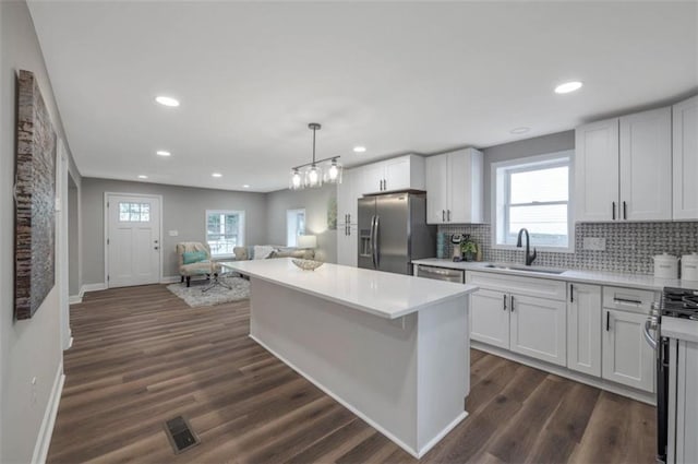 kitchen featuring white cabinets, dark hardwood / wood-style flooring, stainless steel fridge with ice dispenser, and sink